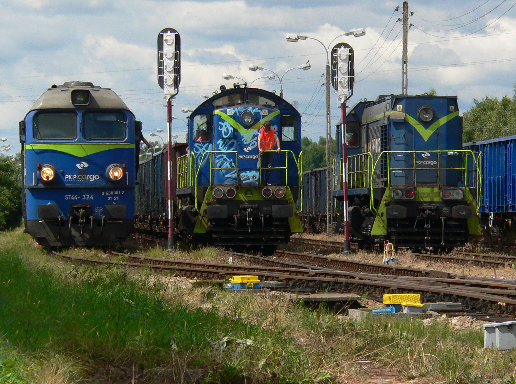 Diesel locomotives waiting at a small freight station.